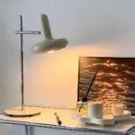 VintageBauhausTwoHeadsSofaBesideGlassFloorLamp