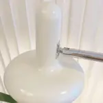 VintageBauhausTwoHeadsSofaBesideGlassFloorLamp 9 2db8c04d 5431 4344 add1 abb553270821
