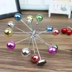 Perpetual motion ferris wheel desk ornament