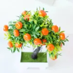 Small artificial potted bonsai fruit tree