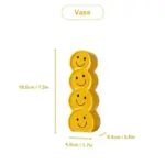 Smiling faces ceramic vase with artificial flowers
