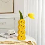 Smiling faces ceramic vase with artificial flowers