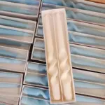 Two pastel coloured household candles