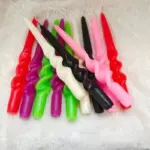 Two pastel coloured household candles